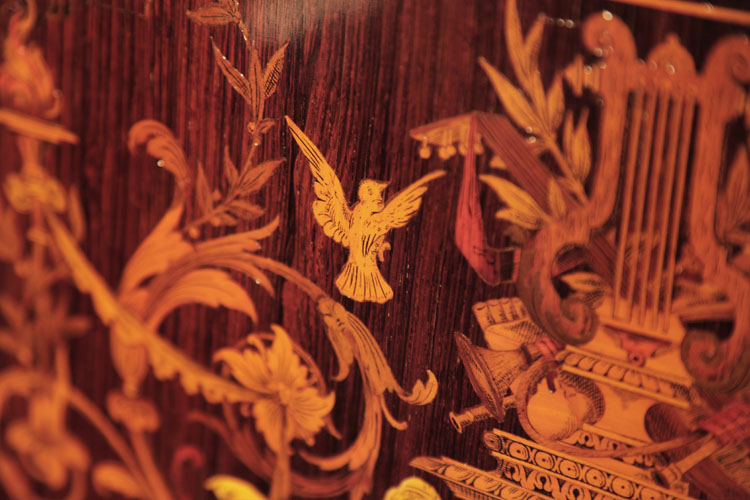 Ascherburg front panel inlay detail of a bird in flight with scrolling flowers and foliage
