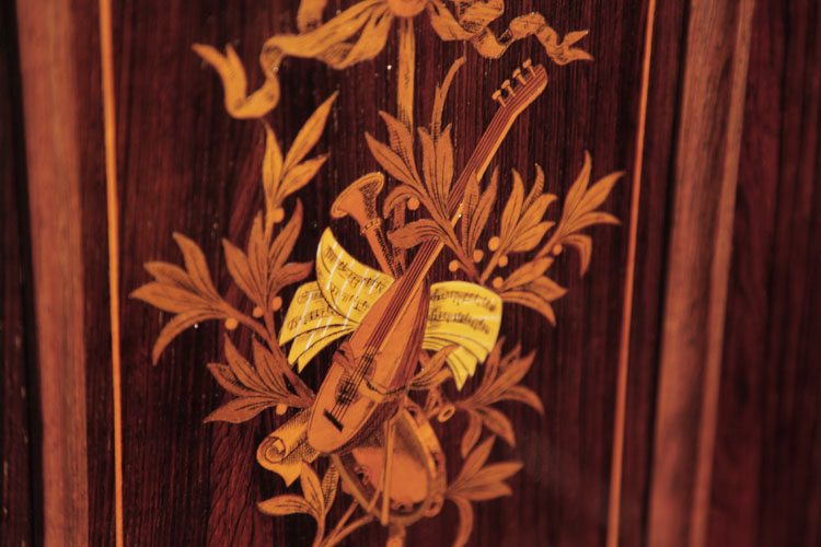Ascherburg side panel inlay detail of musical instruments and sheet music surrounded by myrtle