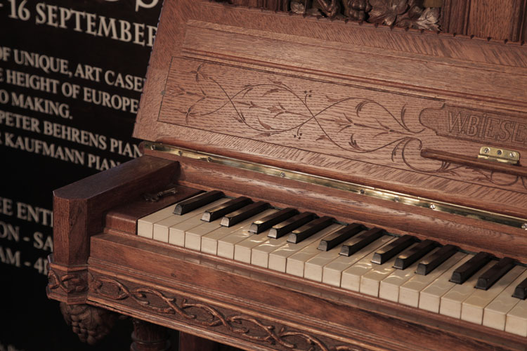 Biese Hof piano fall featuring carved, sylised arabesques