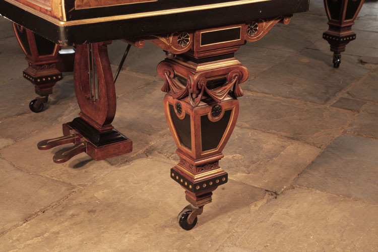 Erard four sided baluster piano leg in black, gold and walnut with carved swagged fabric, black paterae and lotus strapwork embellishment. The pediment features two black paterae with stylised gold hibiscus..