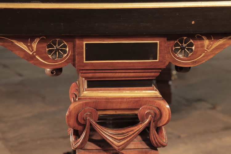 Leg pediment featuring two carved, black paterae and stylised gold hibiscus 