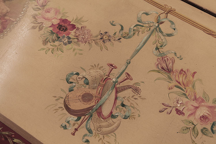 Detail of hand-painted instruments and flowers on cabinet