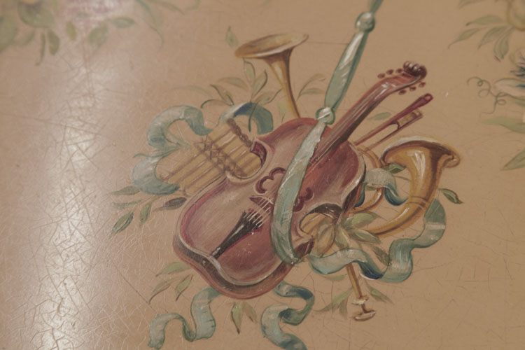 Detail of hand-painted instruments on cabinet