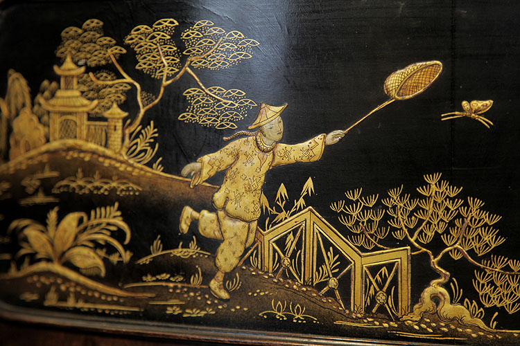 Detail of a boy chasing a butterfly with a net