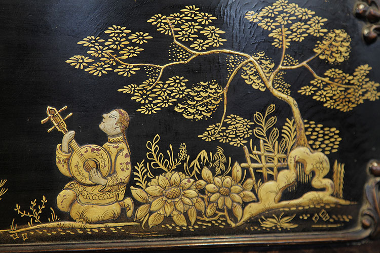 Detail of a boy playing a musical instrument beneath the branch of a tree