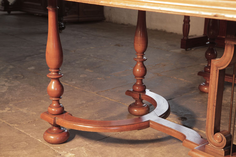 Schiedmayer eight baluster legs with bun feet are fixed to a sinuous cross stretcher