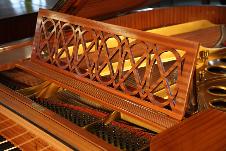 The theme of interlocking circles and squares in the design of this Steinway Model O is repeated in the cut-out music desk