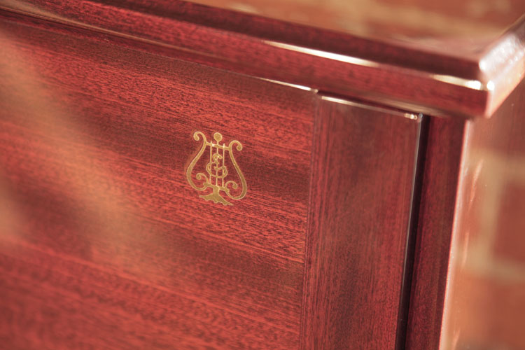 Steinway logo inlaid in brass on the cabinet