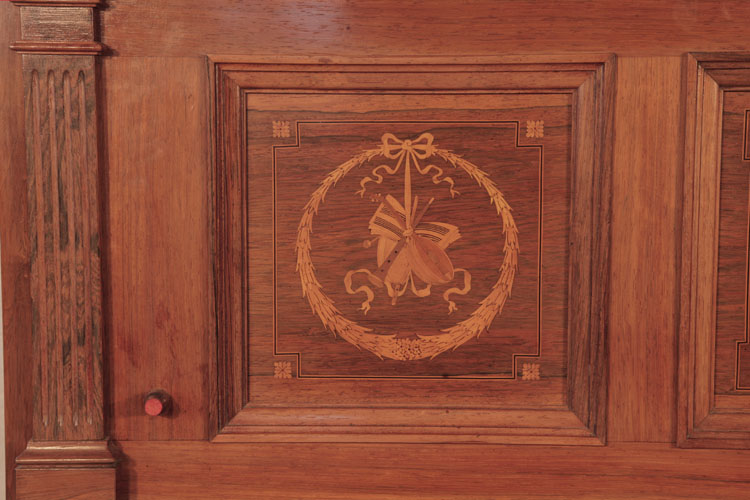	
Steinway pilaster and side panel  inlaid with a circular wreath, tied with a bow and musical instuments