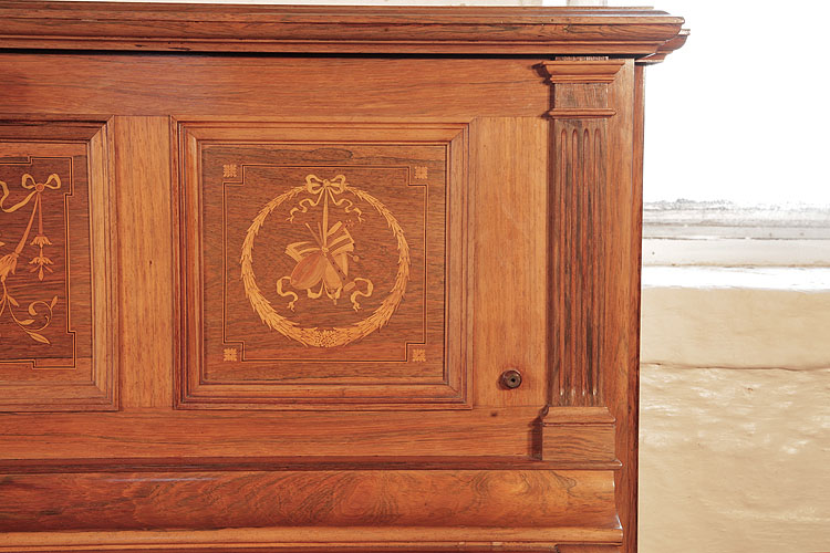 Steinway pilaster and side panel  inlaid with a circular wreath, tied with a bow and musical instuments