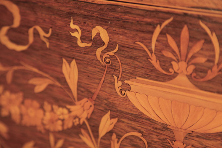 Neoclassical inlay detail of an urn, flowers and ribbons