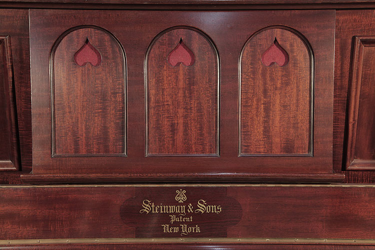 Steinway music desk in a three arch design with cut-out inverted hearts backed with red felt 