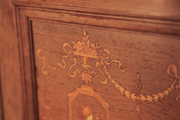 Detail of inlay featuring a central urn filled with flowers, surrounded by fluttering ribbons