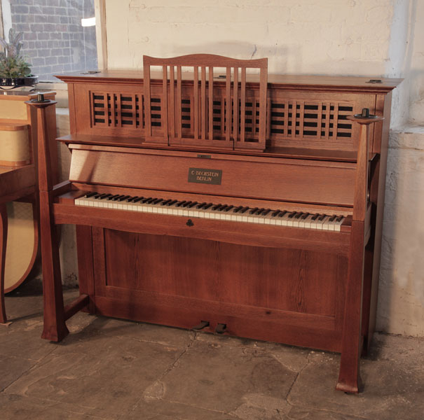  Arts and Crafts style, Bechstein model 9 upright piano with an oak case, architectural candlesticks and ornate iron hinges