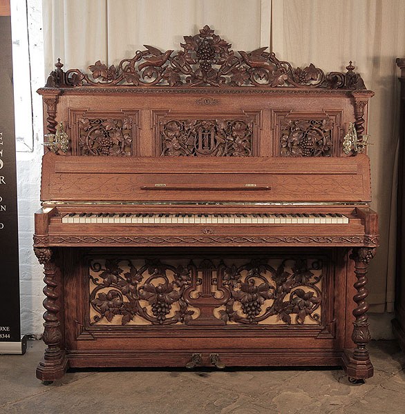 Renaissance style, Biese Hof upright piano for sale with an ornately carved, mahogany case and barley sugar legs.