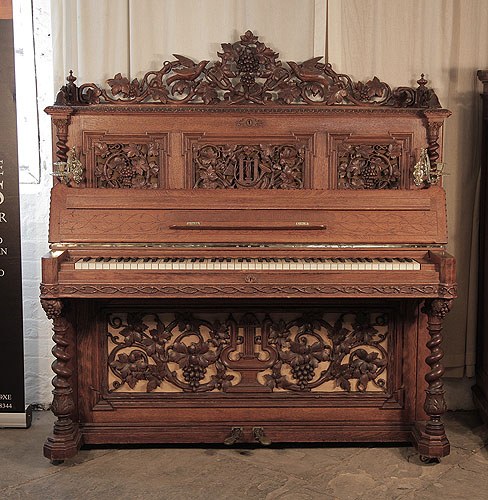 The Golden Age of Pianos. Renaissance style, Biese Hof upright piano for sale with an ornately carved, mahogany case and barley sugar legs 
