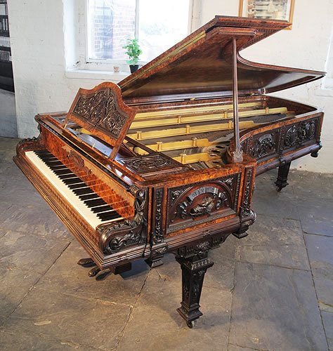 The Breadalbane, 1869, Collard and Collard grand piano with an ornately carved, walnut case. Cabinet features heraldic imagery from the Campbell Clan alongside Neo-classical motifs. 