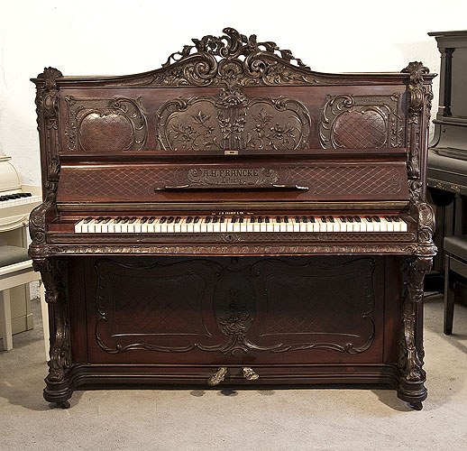 The Golden Age of Pianos. Rococo style, Francke upright piano for sale with a carved, mahogany case and reverse scroll legs. Entire cabinet features ornate carvings of scrolling acanthus, flowers, foliage and rocailles 