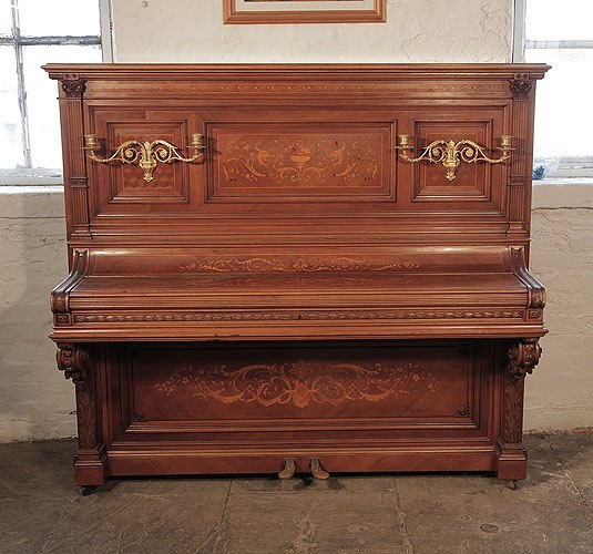 Golden age of pianos. Albert Gast upright piano for sale with a quartered, walnut case and ornate, brass candlesticks. Entire cabinet inlaid in Neoclassical designs featuring scrolling acanthus, urns and flowers