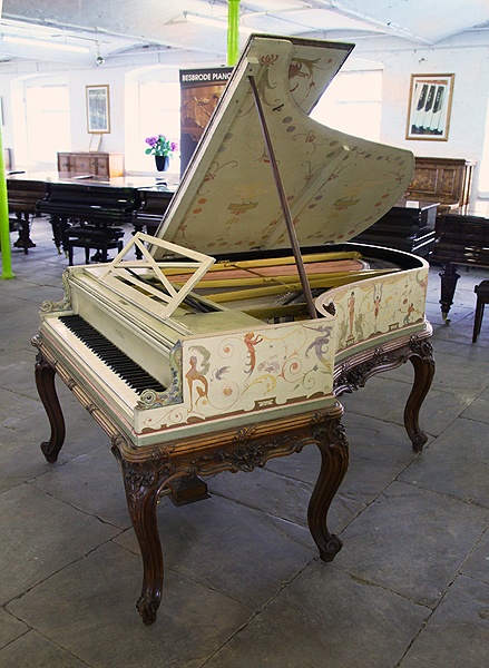 An 1893, Pleyel grand piano beautifully hand-painted with a fairies, satyrs, nudes, monkeys, mythical creatures, birds, flowers and crested composers names. Signed by G. Meunier