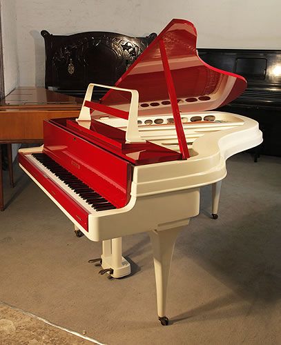 Golden Age of Pianos. A 1959, Rippen grand piano with a contrasting cherry polyester and painted aluminium case. This Rippen piano has a beautiful slimline outline and minimal openwork music desk. Piano features a reverse crown soundboard and tapered legs.