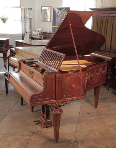 Golden Age of Pianos. A 1901, Schiedmayer grand piano for sale with a quarter cut mahogany case. Entire cabinet features ormolu mounts of beading, swags, bows and festoons. 