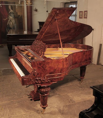 Golden age of pianos. Rebuilt, Schiedmayer grand piano for sale with a burr walnut case and turned, faceted legs. Filigree music desk features a cut-out floral design. Sinuous piano cheek features carved acanthus,scrolls and double case moulding in high reliefs