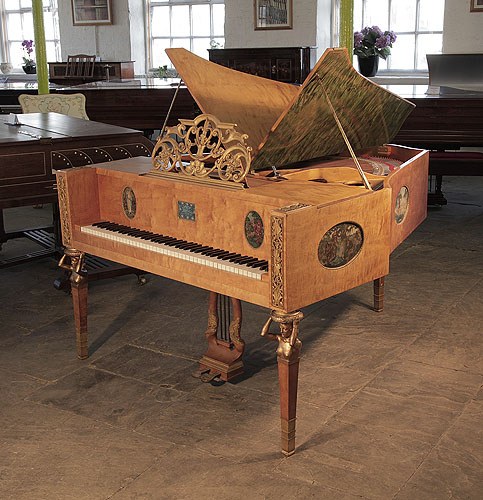 A 1918, Soren Jensen grand piano for sale with a maple case, ornately carved music desk and bronze nude, caryatid legs. Cabinet features hand-painted ovals by Danish artist Gudmund Hentze. 