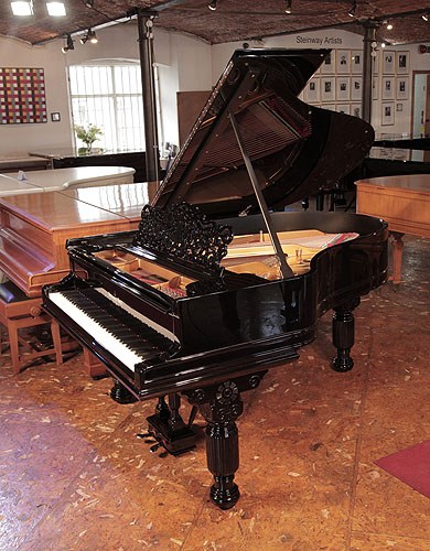 Golden Age of Pianos. Rebuilt, 1883, Steinway Model A grand piano for sale with a black case. Music desk is in a cut-out arabesque design with central lyre motif. Piano has fluted, elephant legs with a pediment carved with a stylised flower and scrolls.