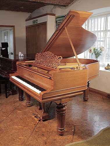 Golden Age of Pianos. Rebuilt, 1900 Steinway Model A grand piano with a walnut case, filigree music desk and fluted, barrel legs with gadrooning detail.