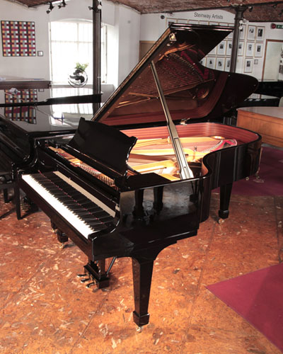The Golden Age of Pianos. Reconditioned, 2008, Steinway Model B grand piano with a with a black case and spade legs