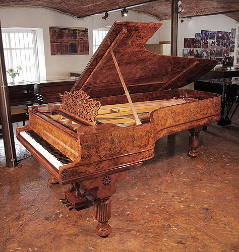 Golden Age of Pianos. Rebuilt 1881, Steinway & Sons Model D concert grand piano with a burr walnut case, filigree music desk and fluted, barrel legs