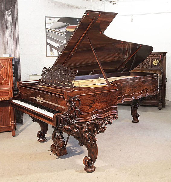 Rebuilt, 1874, Steinway & Sons Style 1 concert grand piano for sale with a rosewood case, filigree music desk and ornately carved, reverse scroll legs 