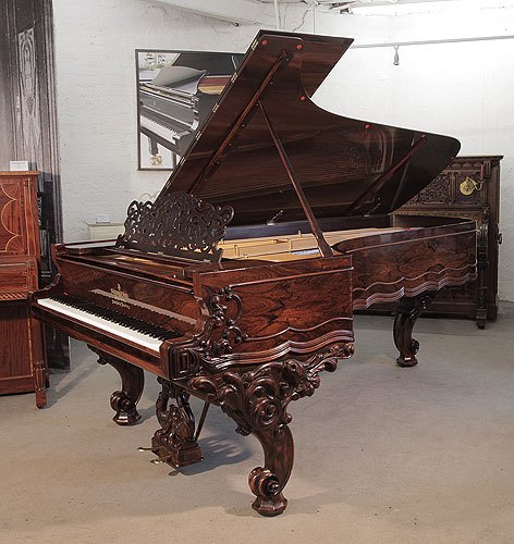 Golden Age of Pianos. Rebuilt, 1874, Steinway & Sons Model D concert grand piano for sale with a rosewood case, filigree music desk and ornately carved, reverse scroll legs. Cabinet features Rococo styling.