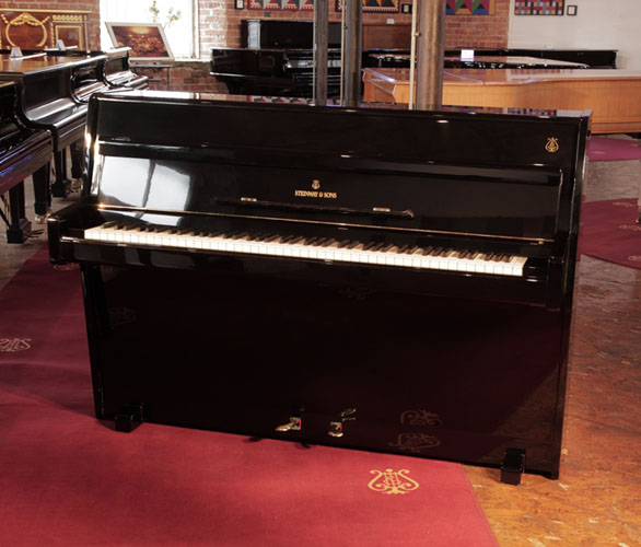 Golden Age of Pianos. Reconditioned, 1960, Steinway Model F upright piano for sale with a black case and brass fittings.