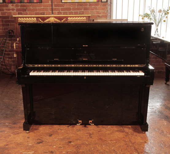 Golden Age of Pianos. Reconditioned, 2002, Steinway Model V upright piano with a polished, black case with brass fittings. Piano frame signed by Lang Lang. 