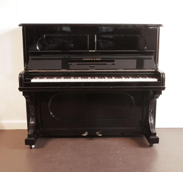 Reconditioned, 1887, Steinway upright piano with a black case and indented front panels