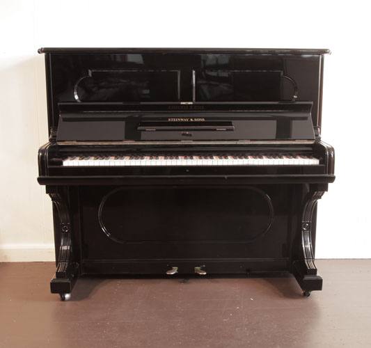 The Golden Age of Pianos. Reconditioned, 1887, Steinway upright piano with a black case and indented front panels