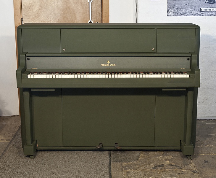 A 1945, Steinway Victory Vertical G.I. upright piano for sale with an olive drab case. This upright was airdropped onto battlefields during WWII for the American troops