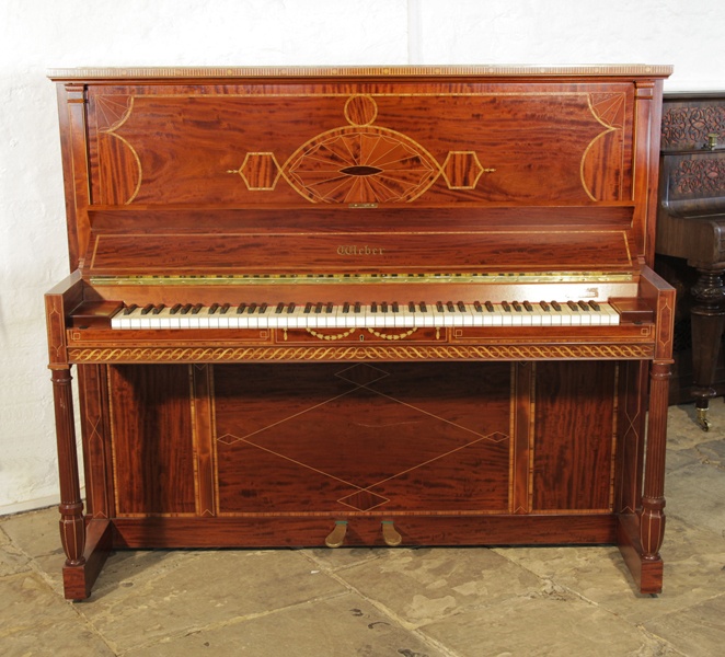 A 1912, Weber upright piano for sale with an inlaid, flame mahogany case and turned, fluted legs